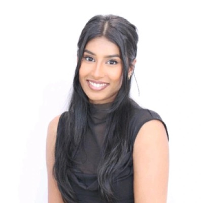 woman with long dark hair and black sleeveless top, white background