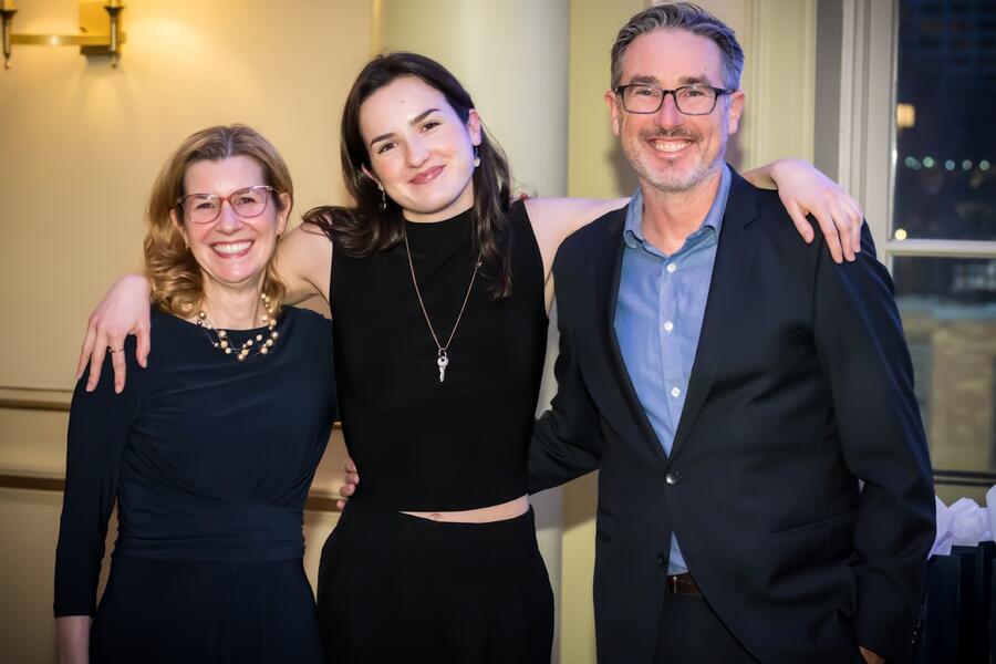 3 individuals with arms around each other smiling at the camera