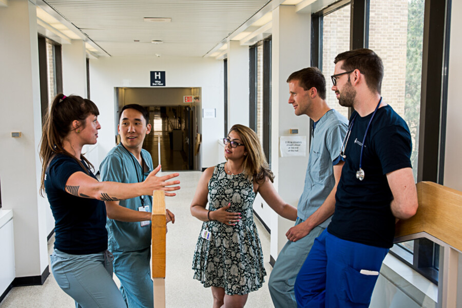 Group of physicians talking in a hospital corridor