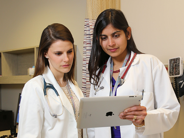 Physicians looking at a tablet