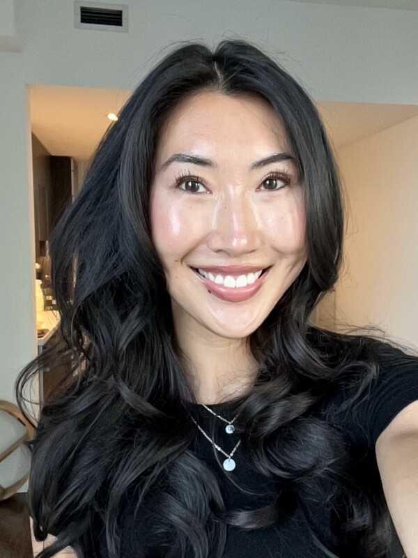 Asian woman with long curled black hair
