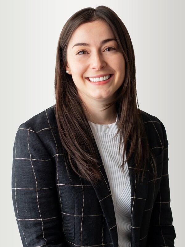 white woman with long dark hair, wearing a black blazer