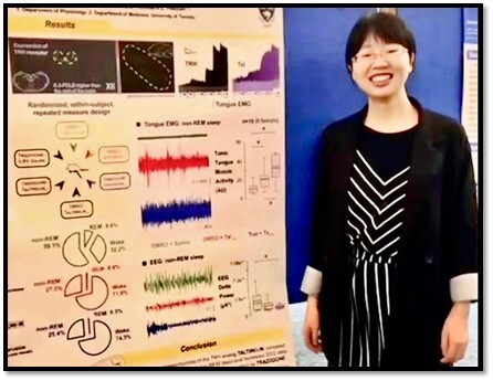 Woman standing next to research poster