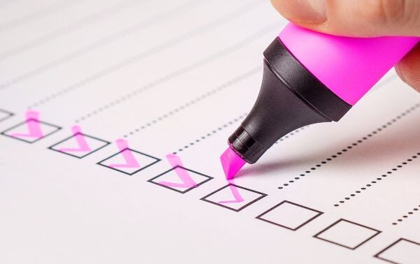 Pink highlighter checking off boxes on a checklist