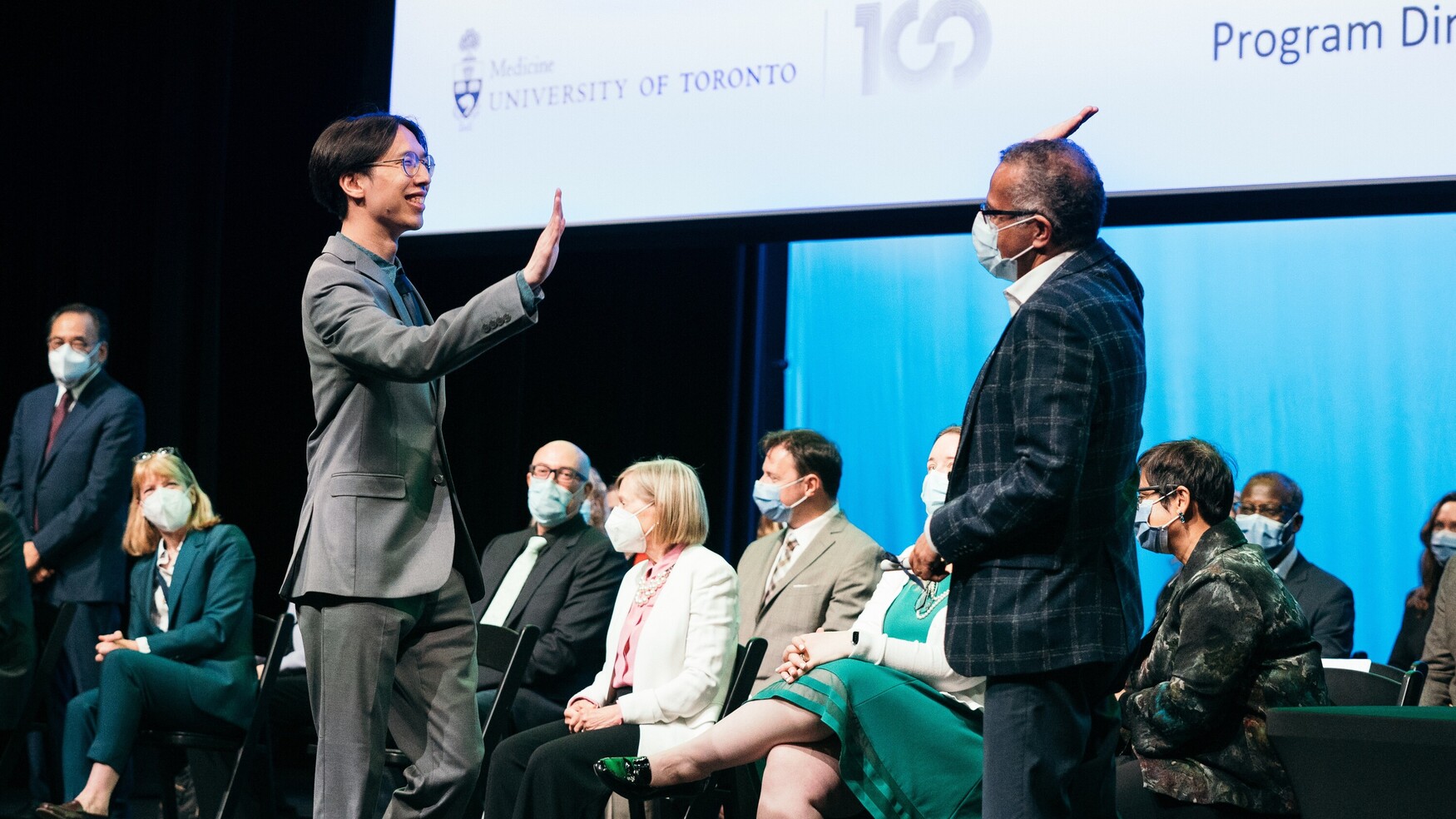 Dr. Anil Chopra high-fives a graduate